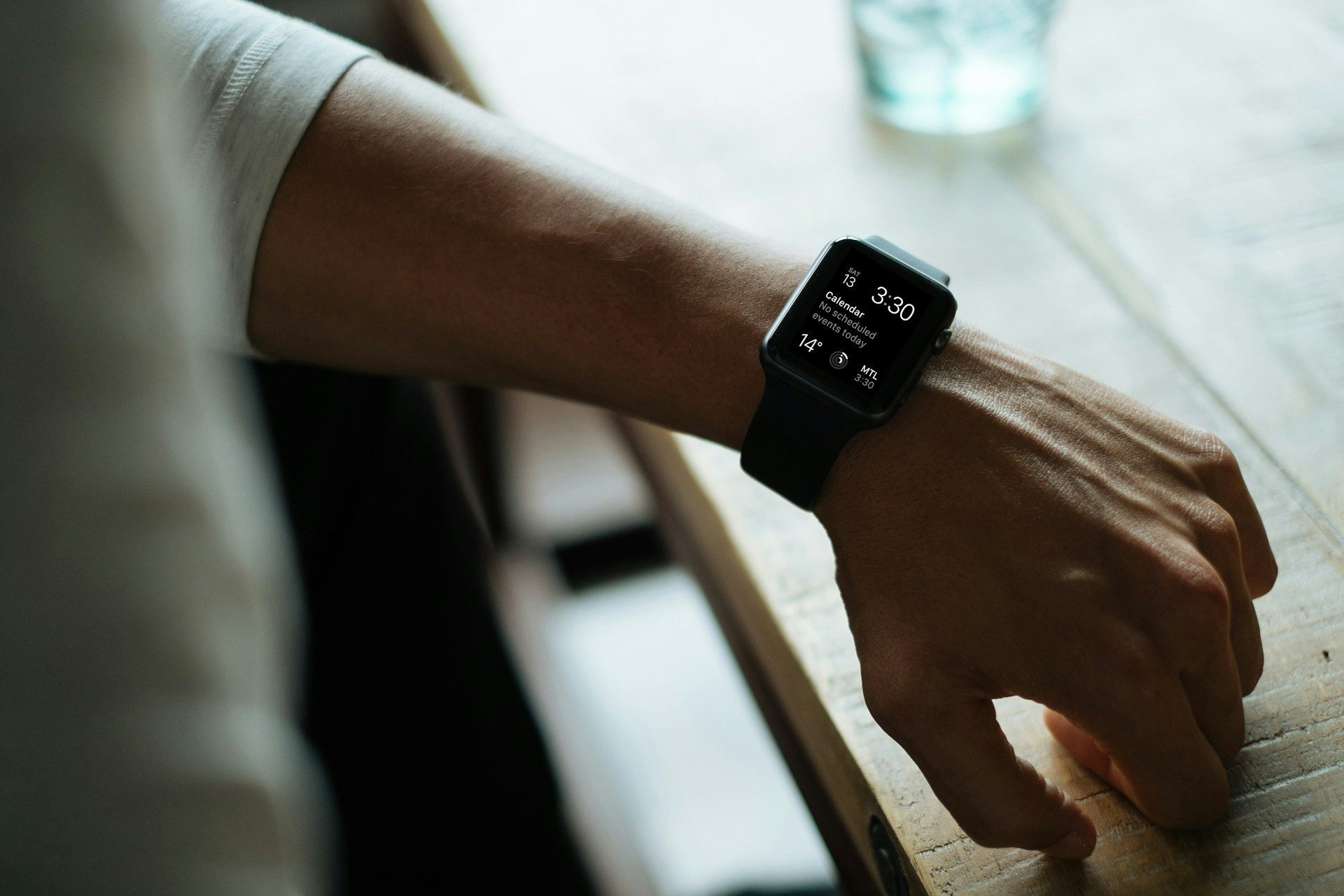 A person wearing an Apple Watch with a low battery.