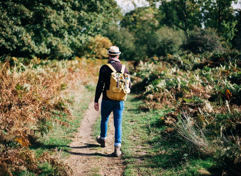 Man walking in nature with backpack