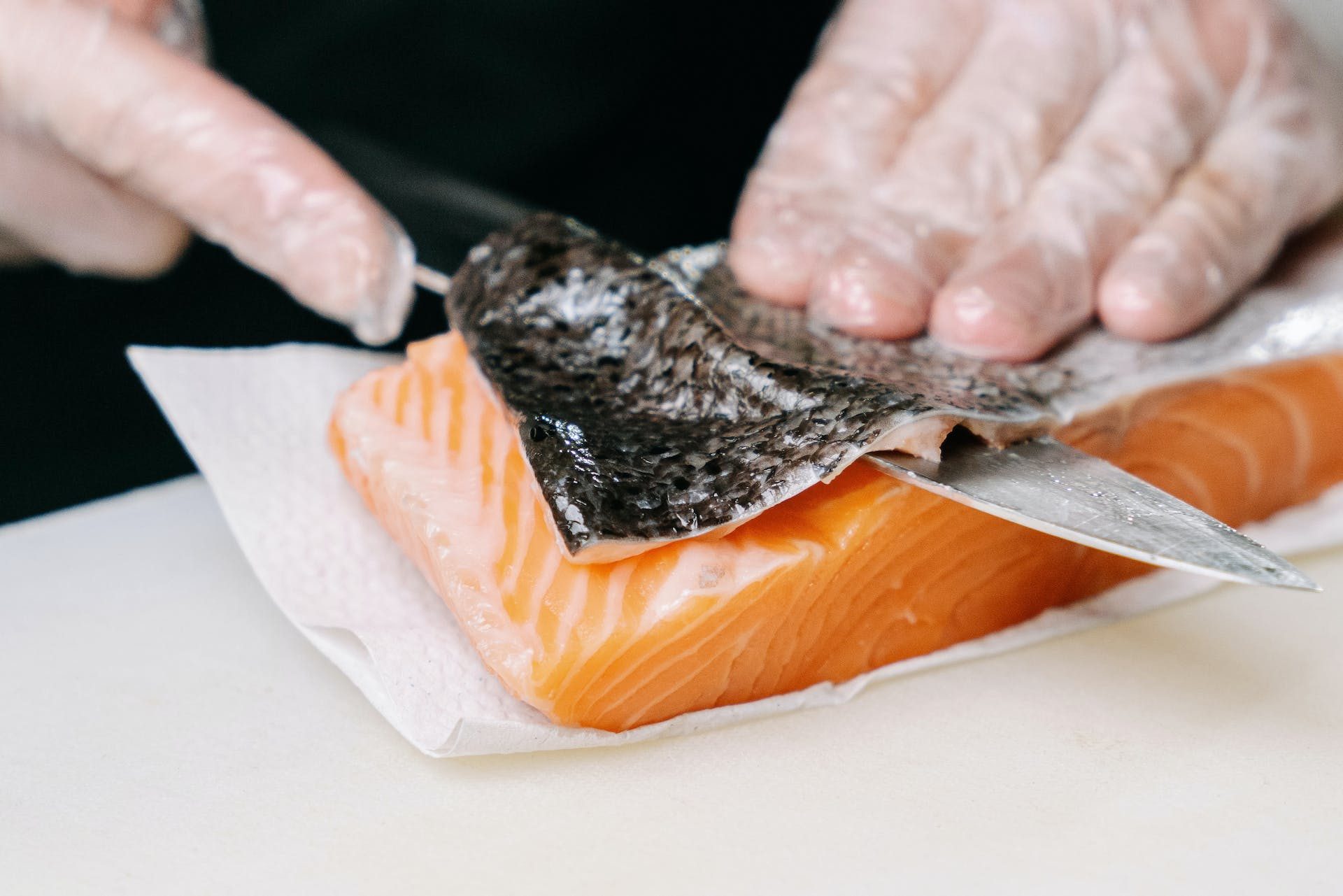 Person removing salmon skin