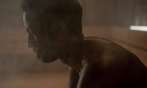 man sitting in sauna