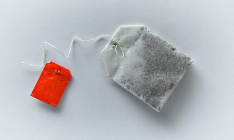 Single tea bag on a white background