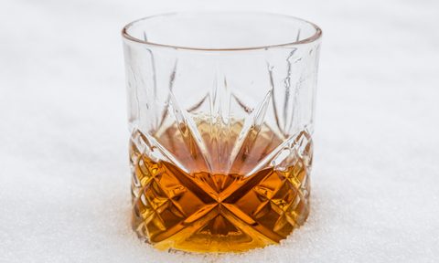Whiskey in a glass on a white background