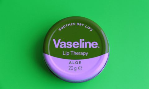 a vaseline lip product on a greenscreen backdrop