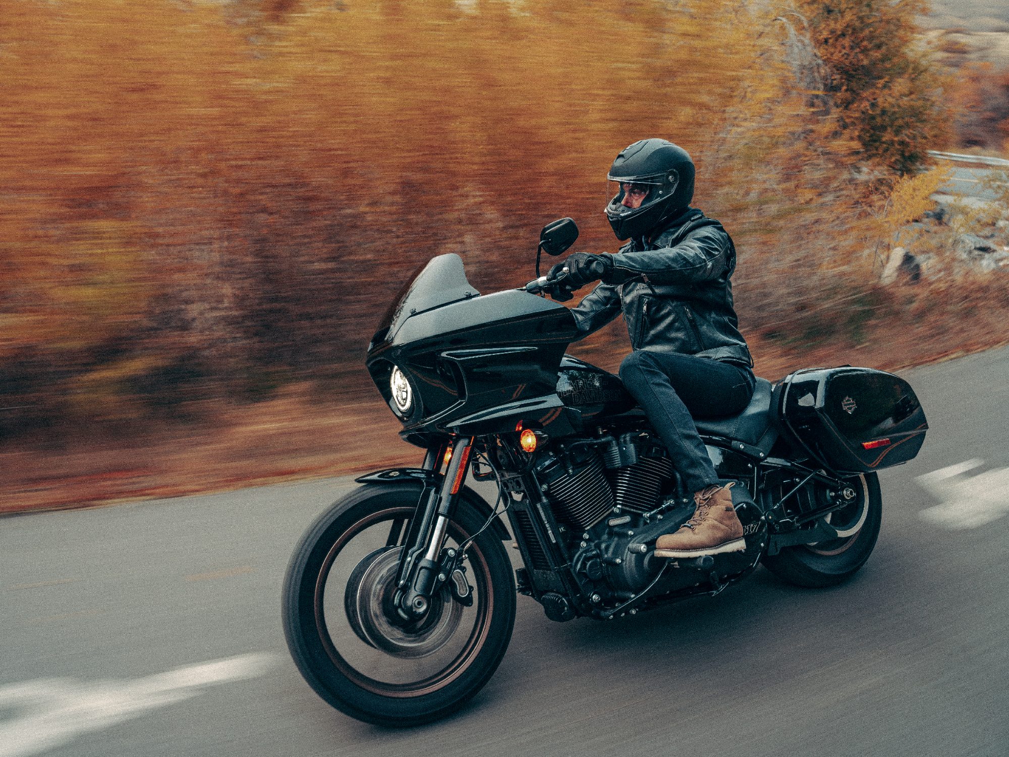 2024 Harley-Davidson Low Rider ST in Vivid Black color with rider left front three-quarter view on highway.