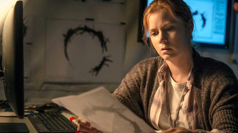 Amy Adams attempts to decipher an alien language in Arrival.