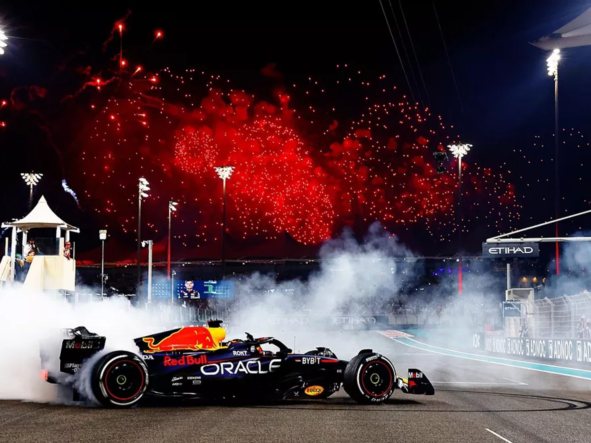 Red Bull's Max Verstappen driving a victory circle.