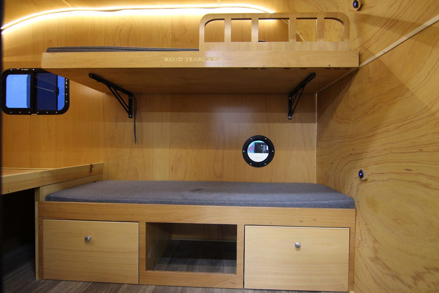Convertible sofa/bunk beds inside Bend Teardrop's Tall Boy high-roof teardrop trailer.