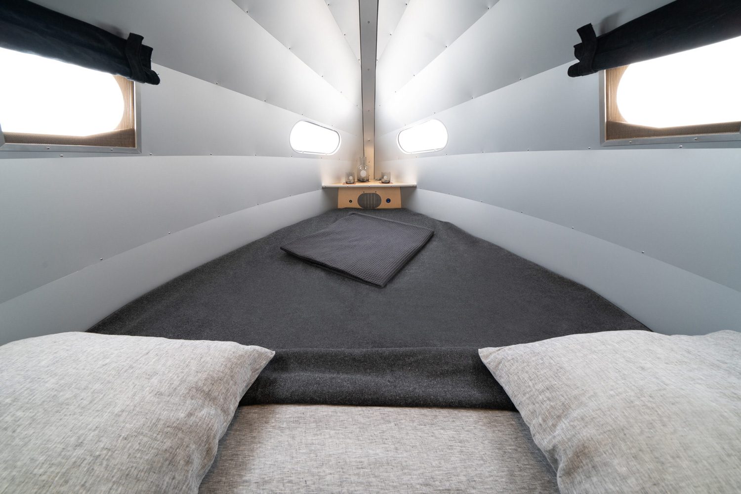 Bed and sleeping quarters of the Bowlus Rivet travel trailer.