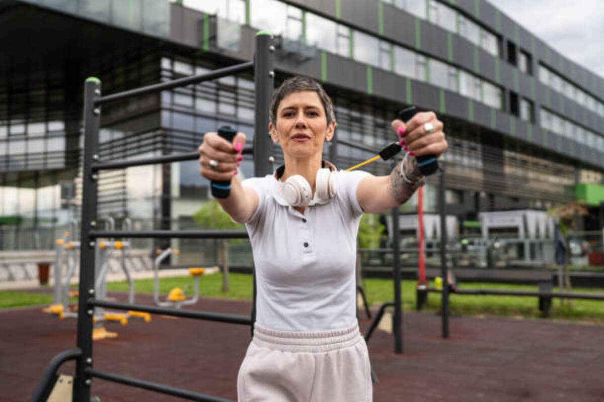 Woman doing resistance band chest press.