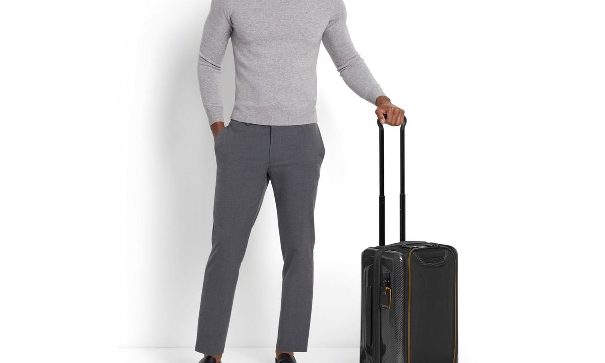 Man holding Tumi luggage by the handle
