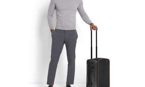 Man holding Tumi luggage by the handle