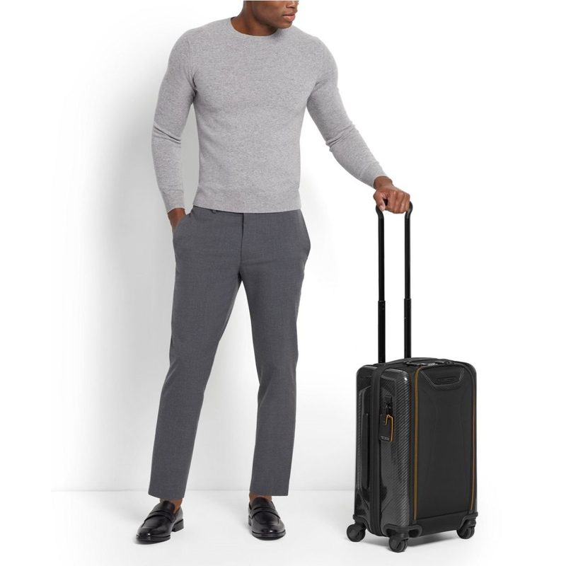 Man holding Tumi luggage by the handle