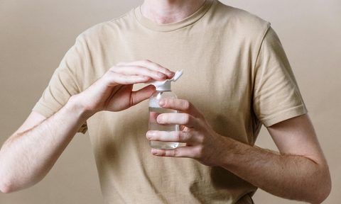 man putting serum on hand