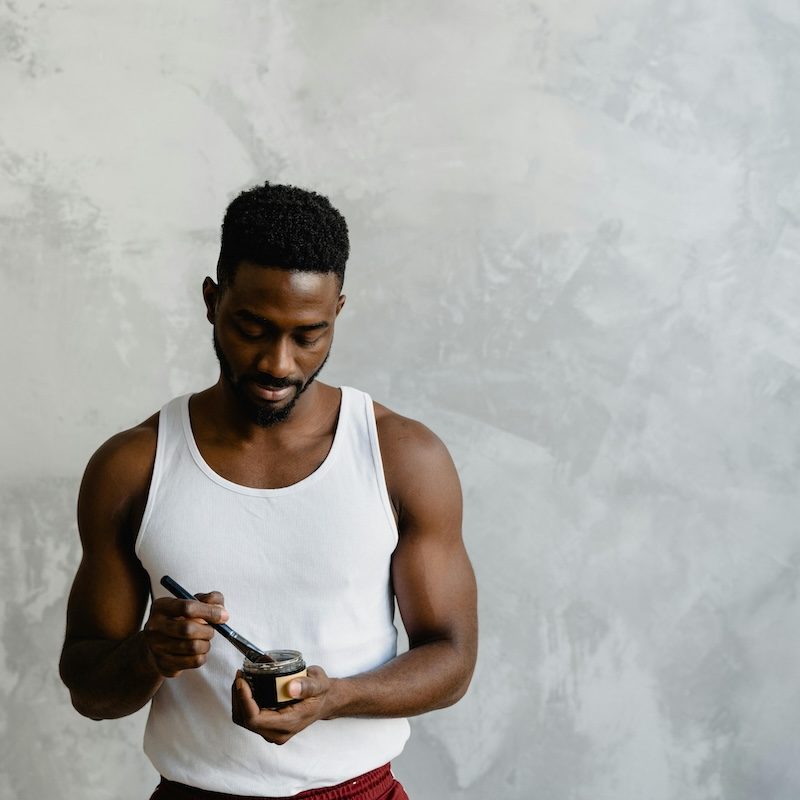 Man holding a skincare product