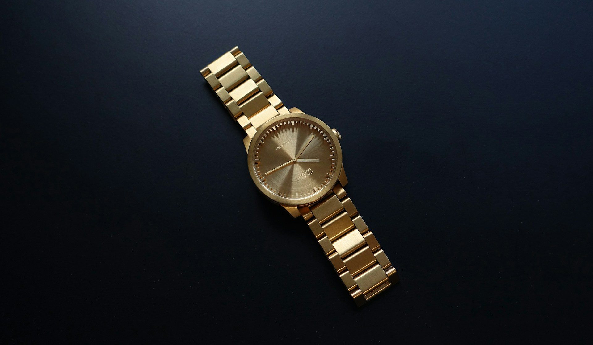 gold watch on table