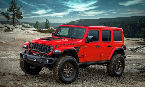 2024 Jeep Wrangler Rubicon 392 Final Edition parked on stone with the ocean in the background and stormy clouds.