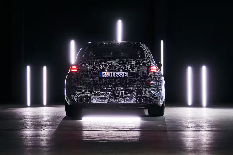 2025 BMW M5 Touring rear view of a camoflaged European model.
