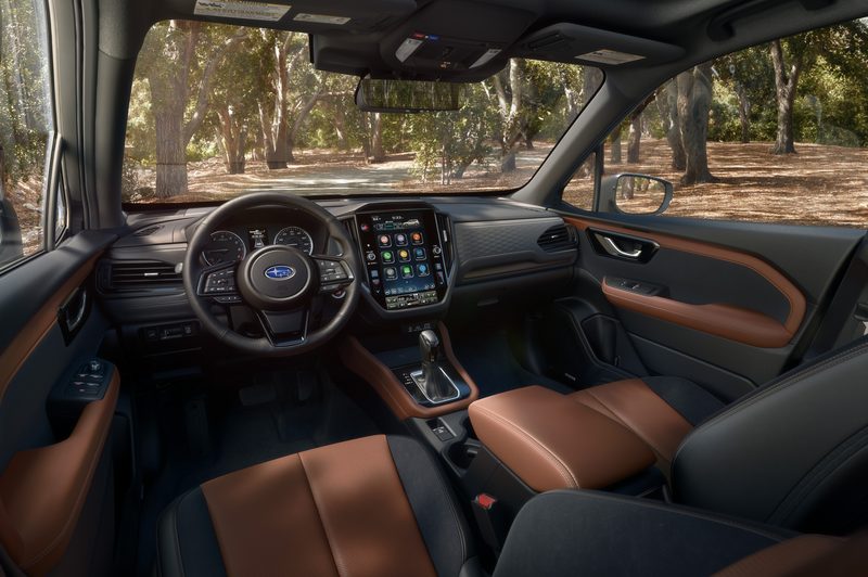 2025 Subaru Forester front row driver and passenger seating with 11.2-inch touch infotainment display on dash.