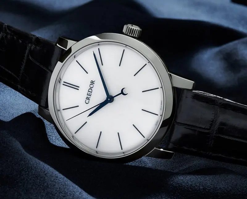 Credor watch on fabric background