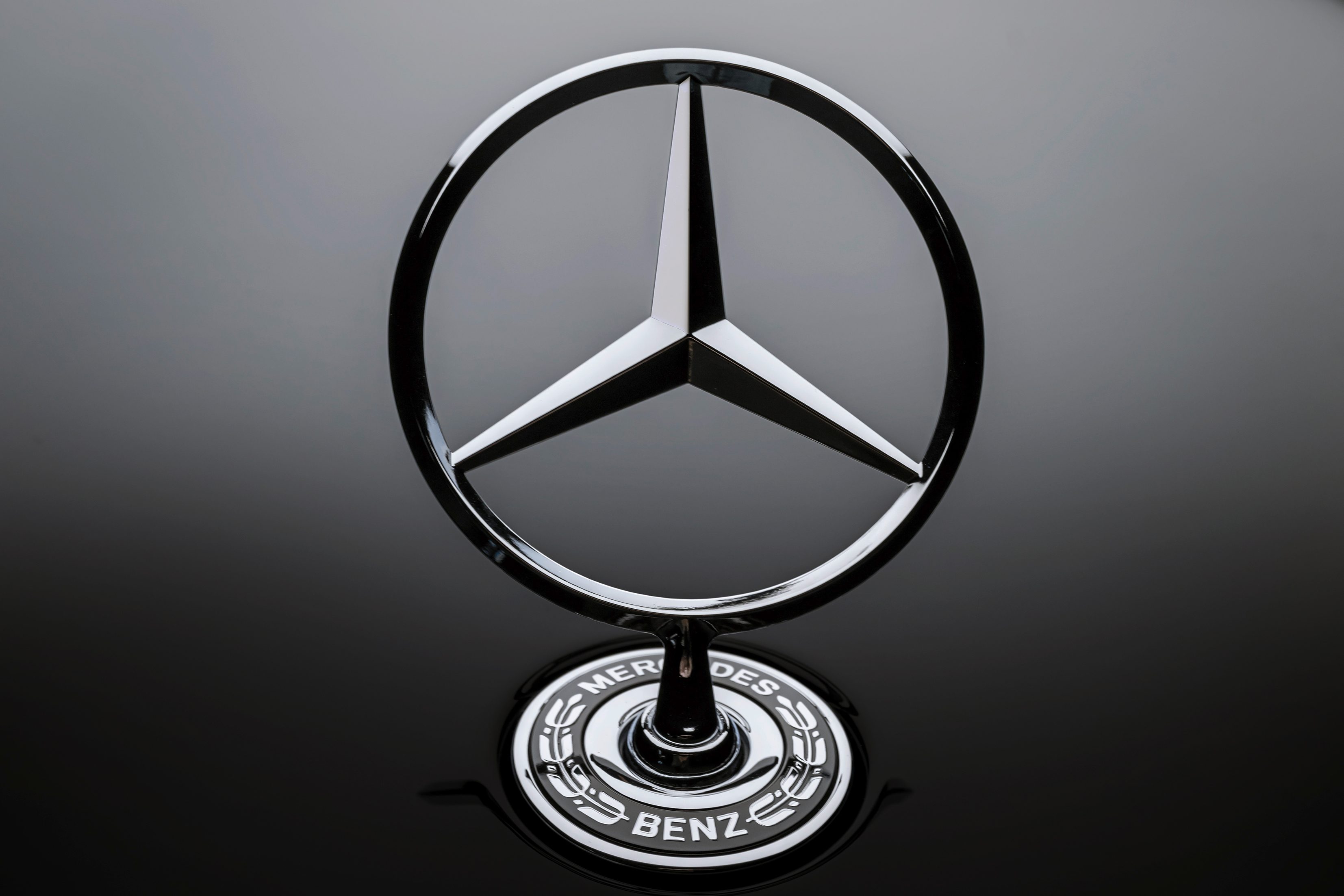 A Mercedes-Benz standing star on the hood of a 2025 Mercedes-Benz EQS in Obsidian Black..