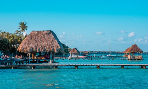 Color graded picture of a pier with clouds and blue water at the Laguna Bacalar, Chetumal, Quintana Roo, Mexico.