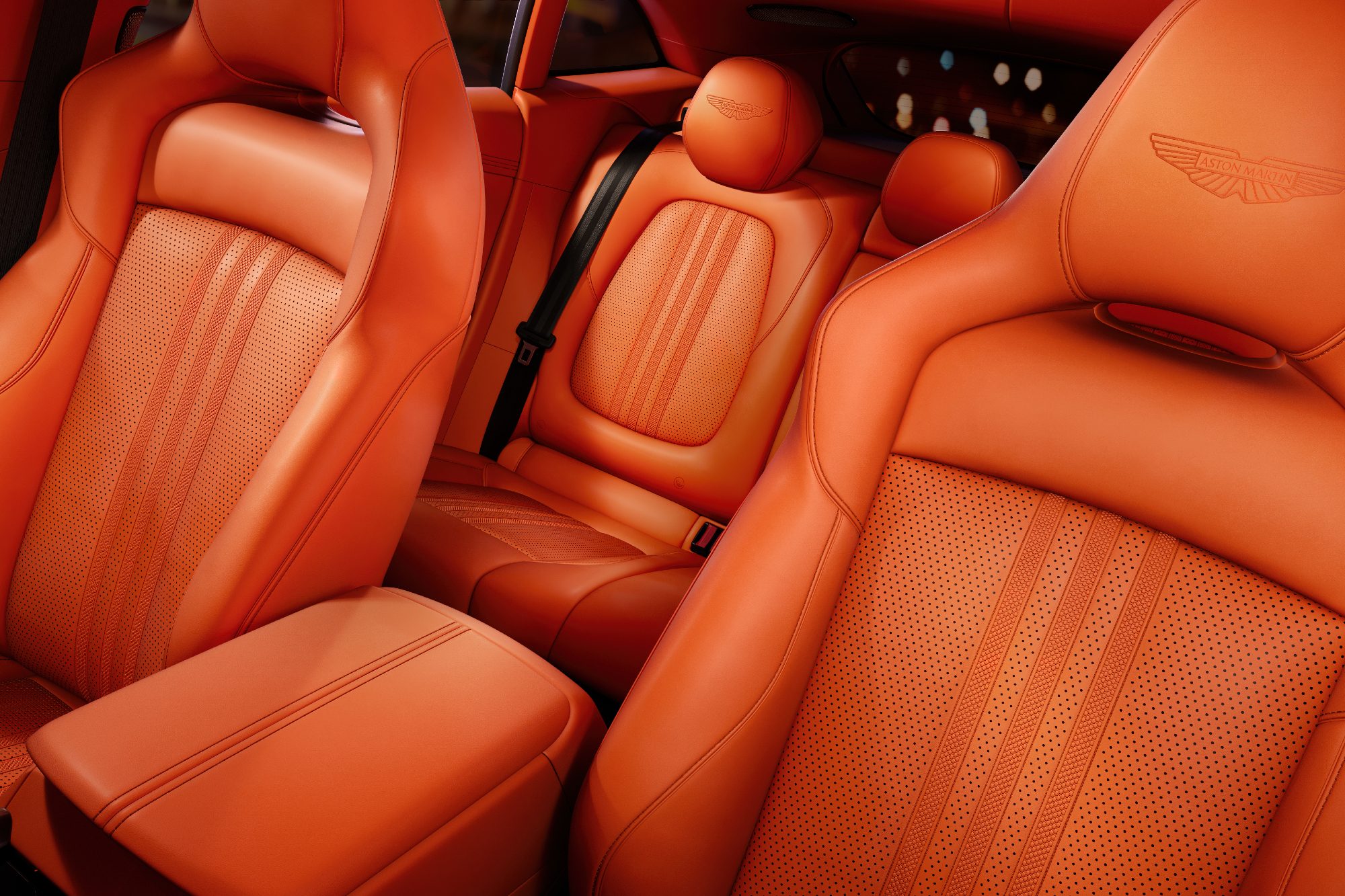 Aston Martin DBX707 new interior showing bright upholstery with perforated surfaces for front and rear seats.