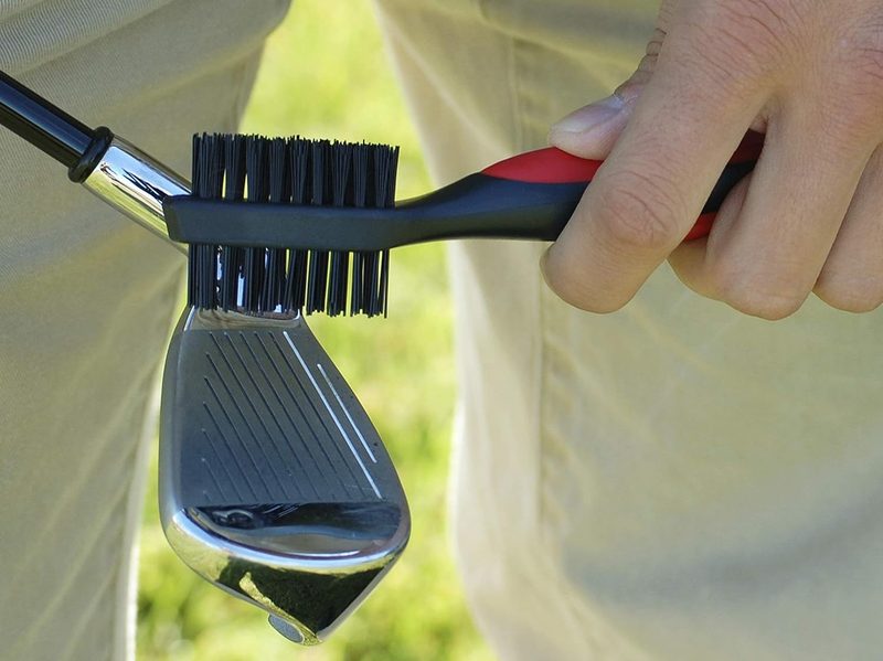 A man using the Callaway Premium Golf Club Brush to clean his club.