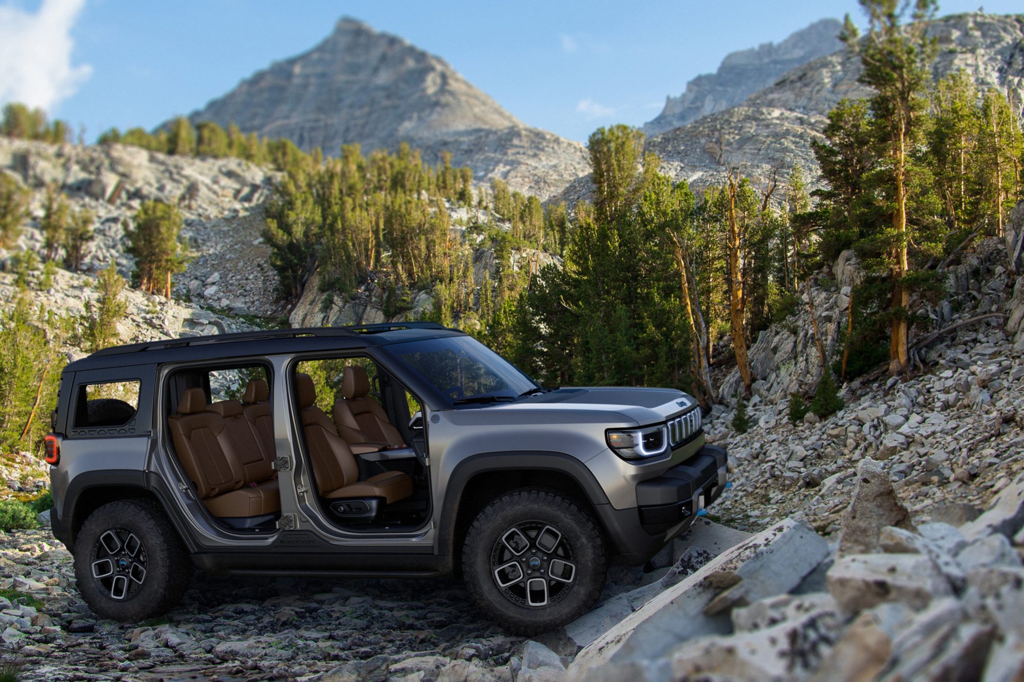 Gray Jeep Recon concept EV with doors off at the bottom of a rocky incline.