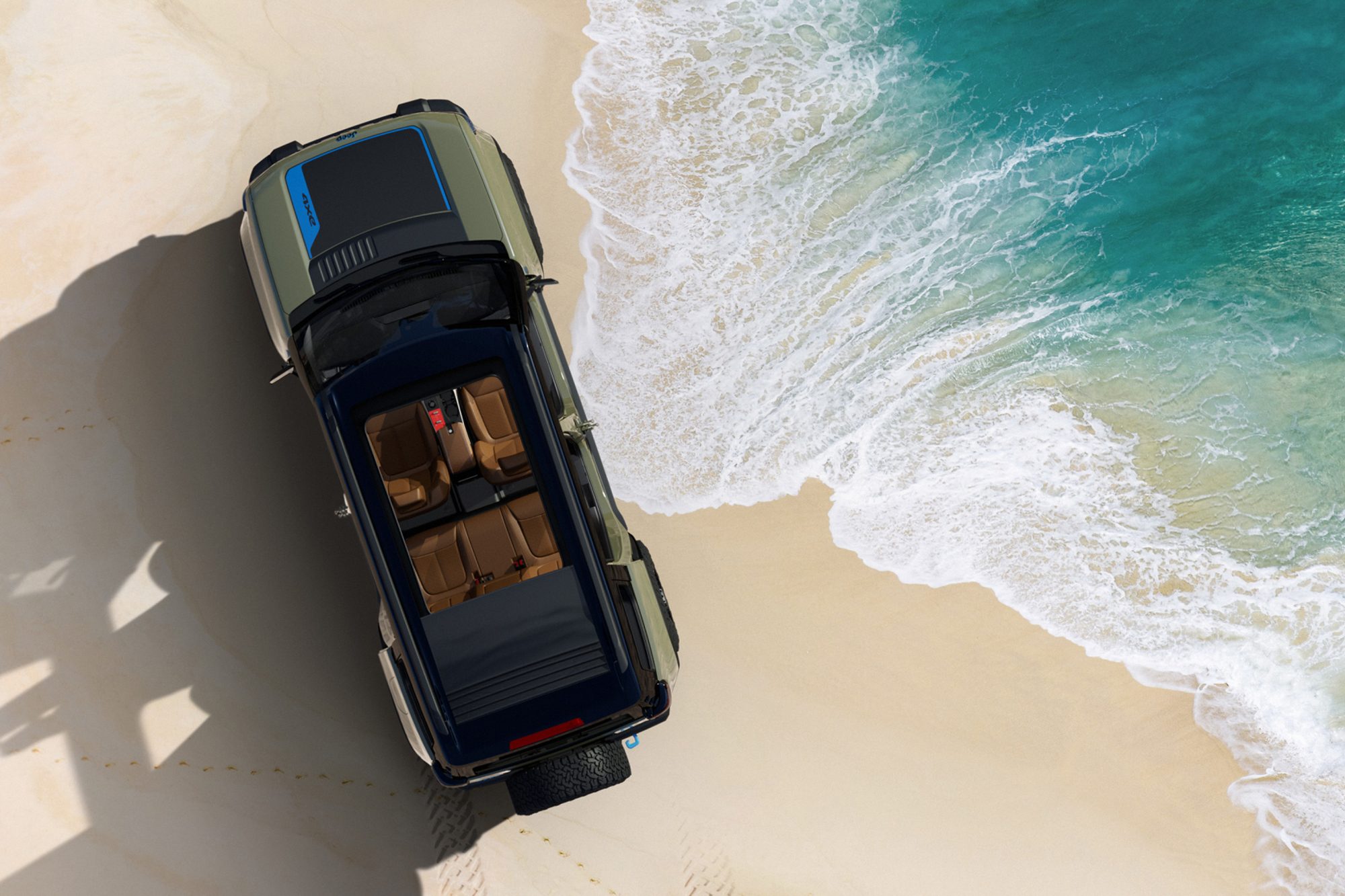Green Jeep Recon concept EV on a beach with water almost reaching it overhead shot showing four seats through pushed back top.