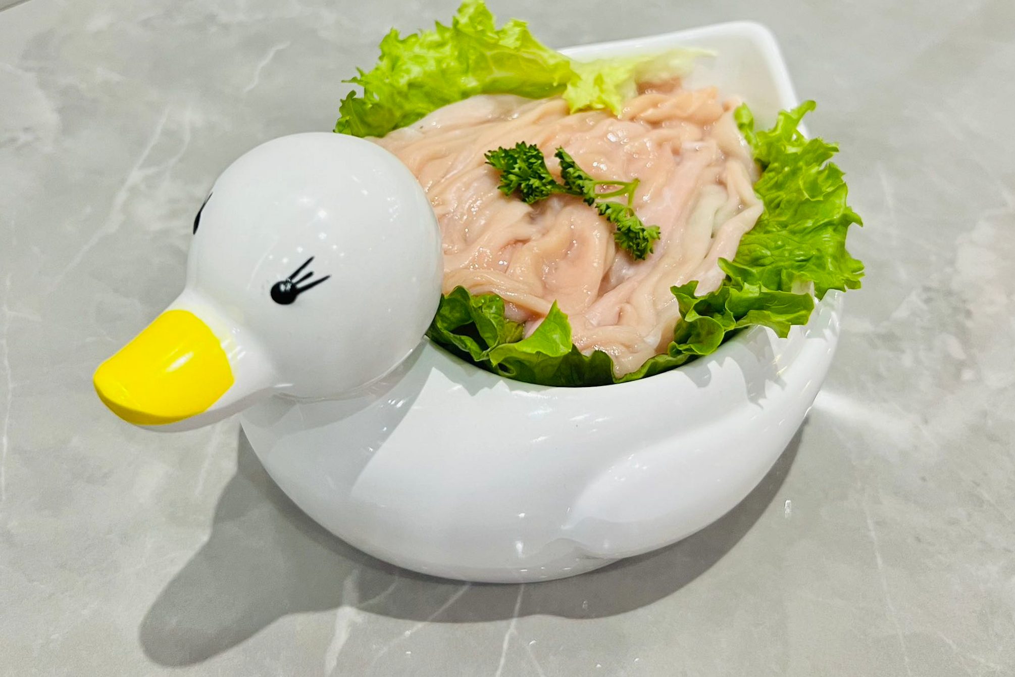 Goose intestines in duck ceramic container.