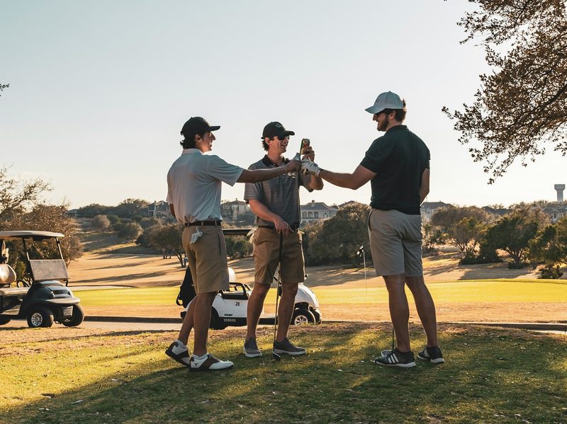 Men drinking and playing golf.