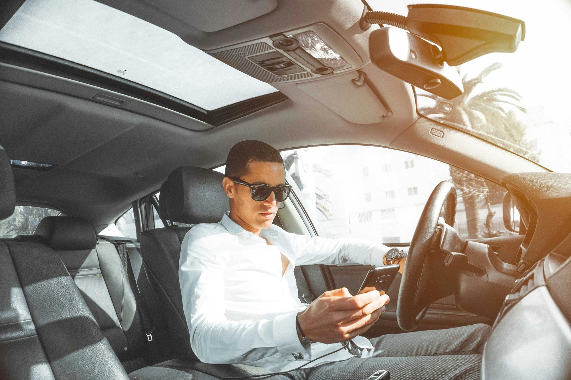 Man in a car on his phone