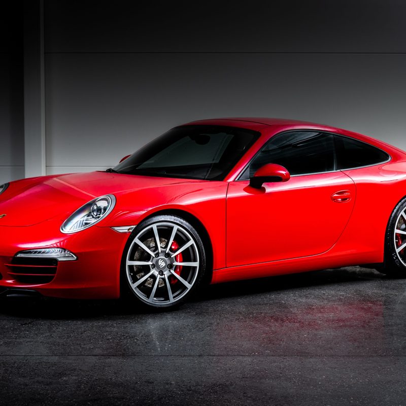 Red porsche 911 carrera in garage