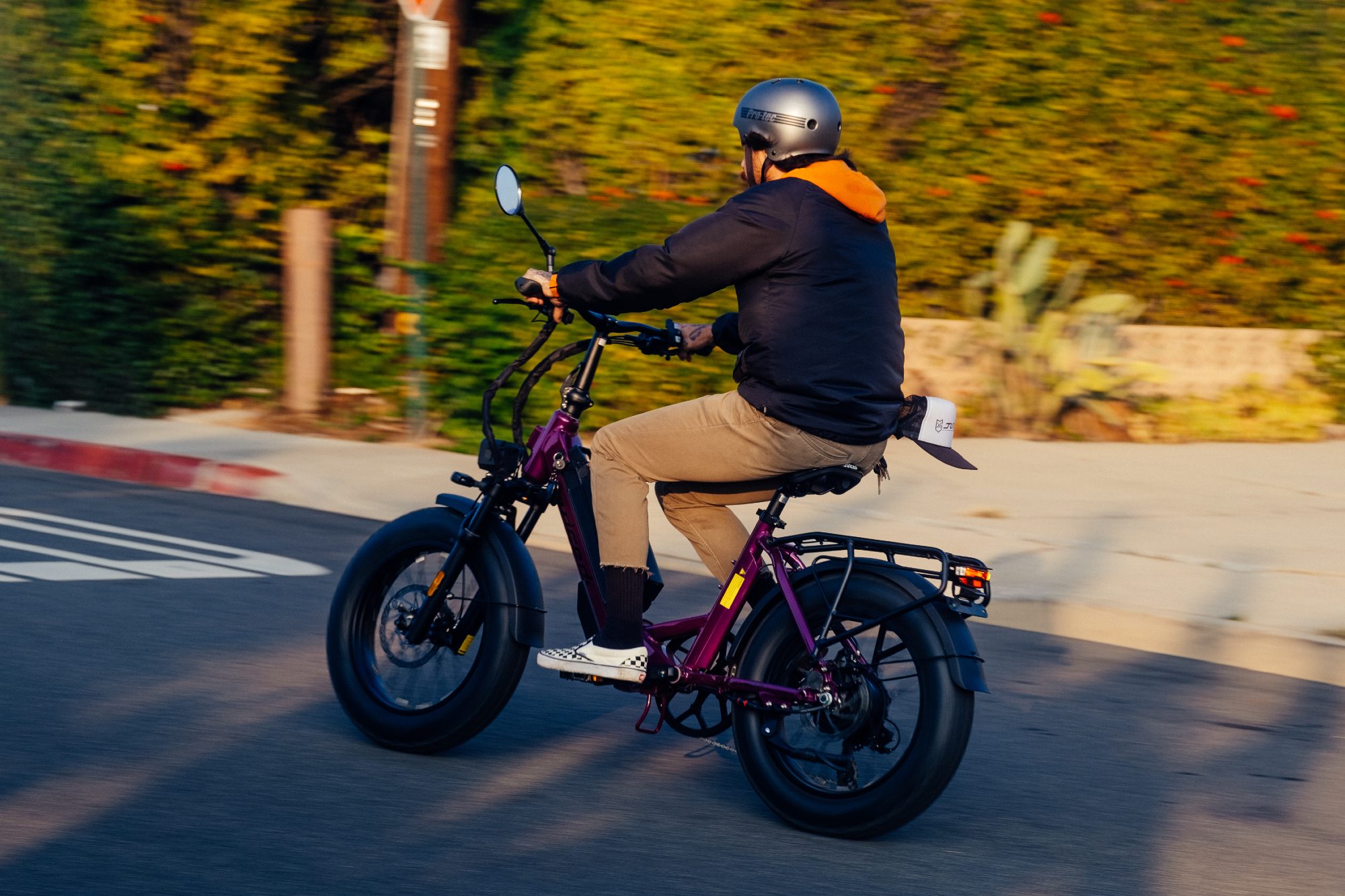 Rider on city street on a Purple Haze Juiced Bikes JetCurrent Pro e-bike.