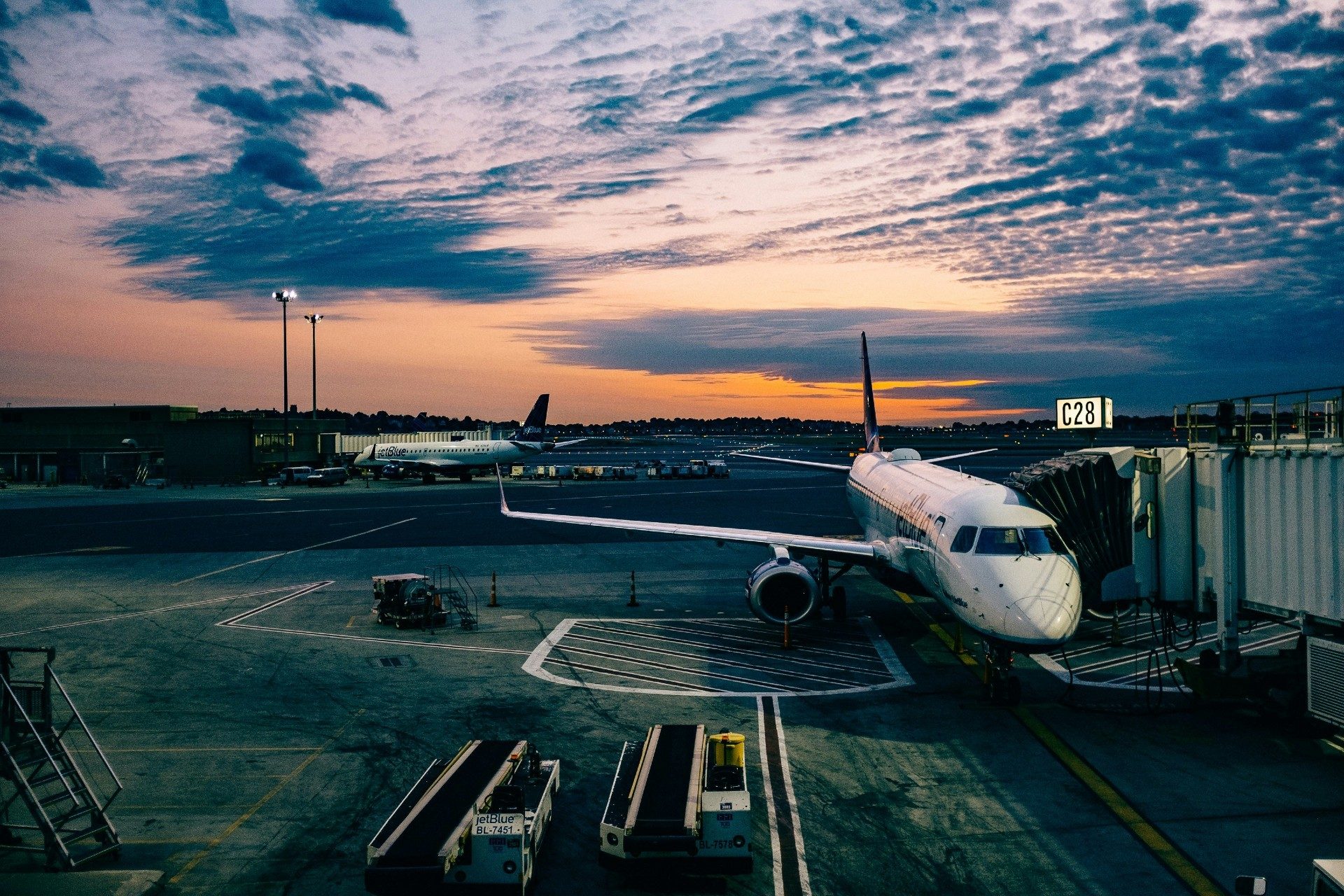 Airplane at gate during sunset