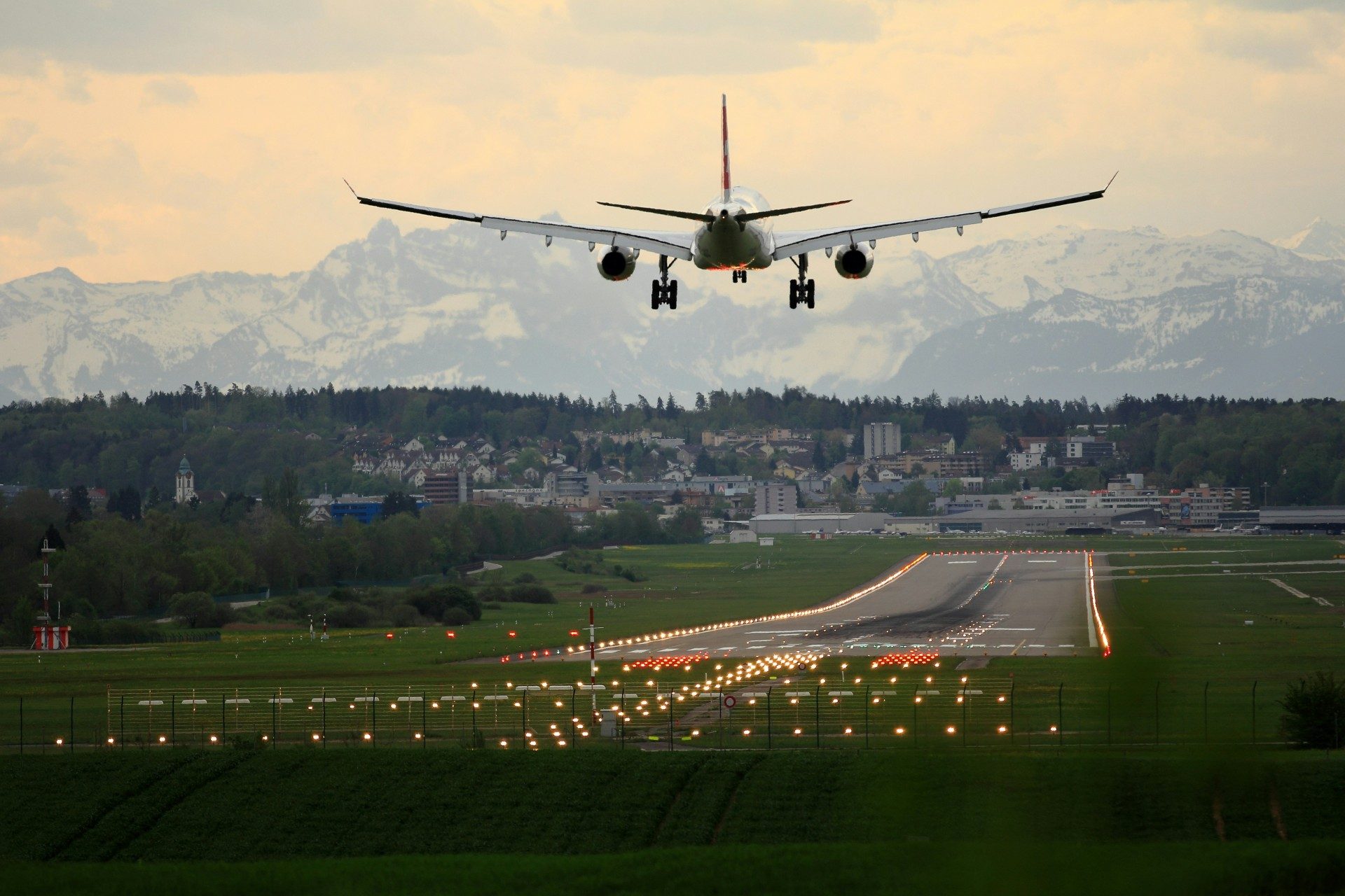 Swiss mountains behind landing airplane