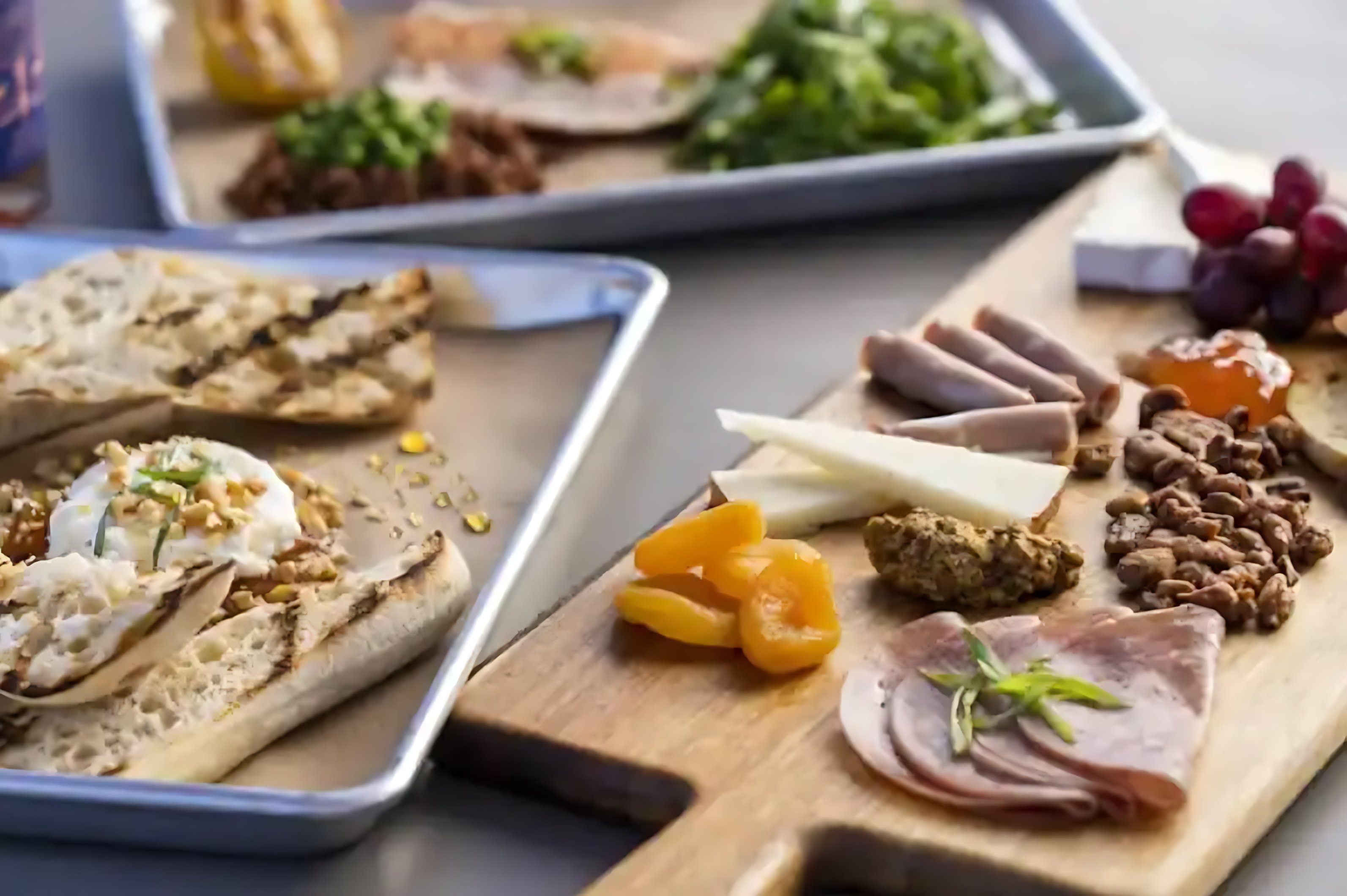 A charcuterie board featuring fresh food items placed on a table