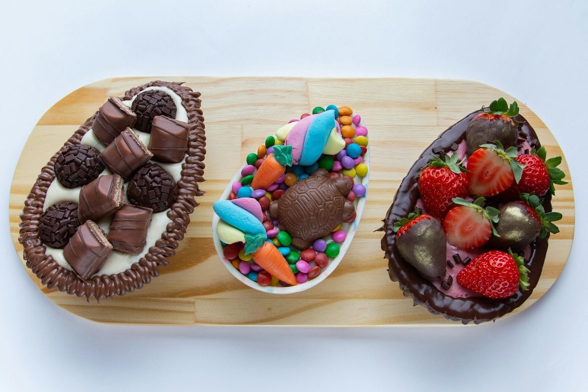 a dessert board including a bowl of chocolate covered strawberries