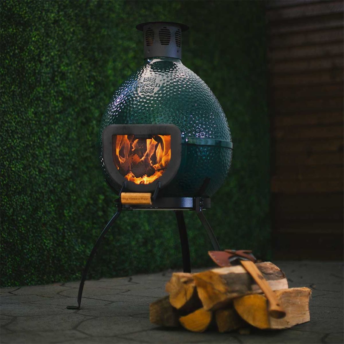 The Chiminea with wood burning in it.