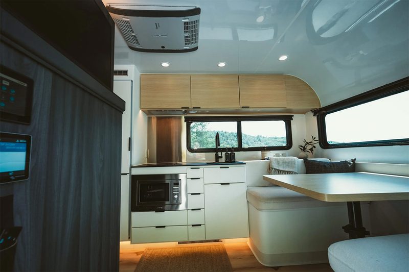 Premium kitchen and dining area inside Coast's Model 1 solar electric trailer/RV.
