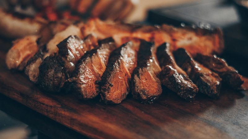 Sliced steak on cutting board