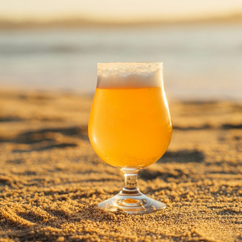 A glass of beer on a beach