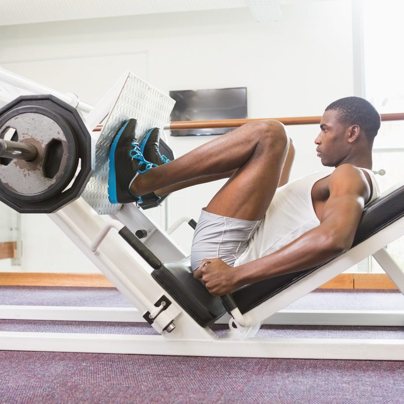 Man doing leg presses in the gym