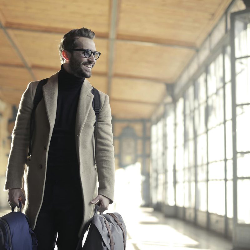 Man carrying bag smiling