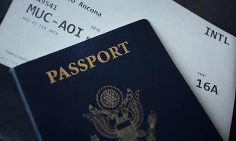 Passport sitting on top of white paper