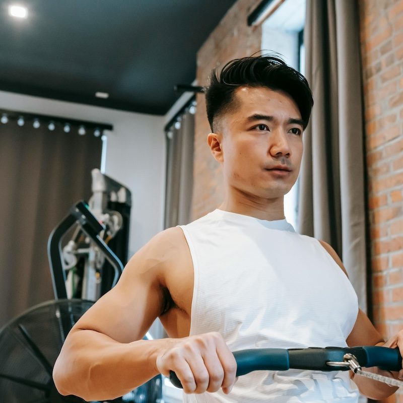 Man on a rowing machine white shirt