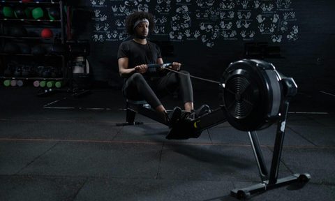 Man using rowing machine.