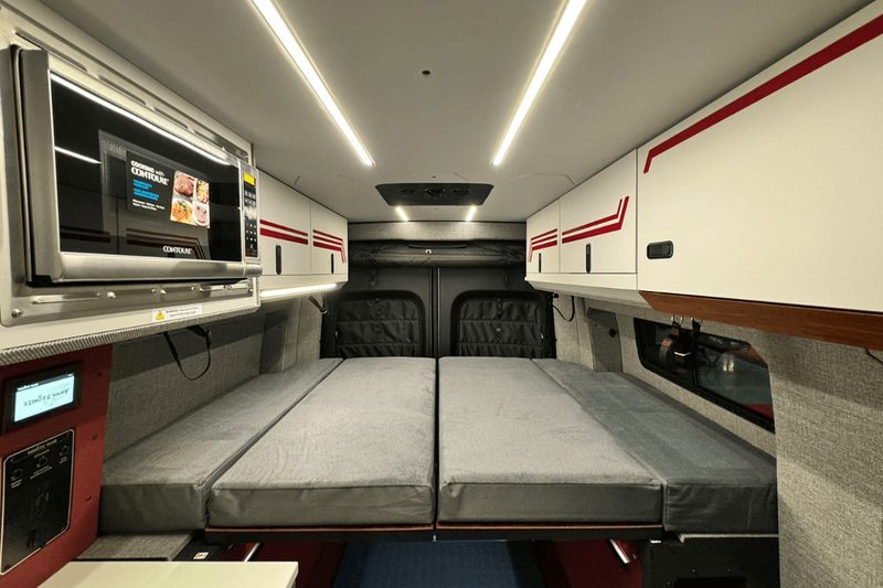 Interior of a Remote Vans camper van with the bed folded down.