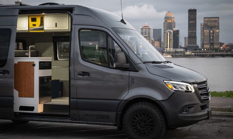 Side view of a Remote Vans camper van with its sliding door open.