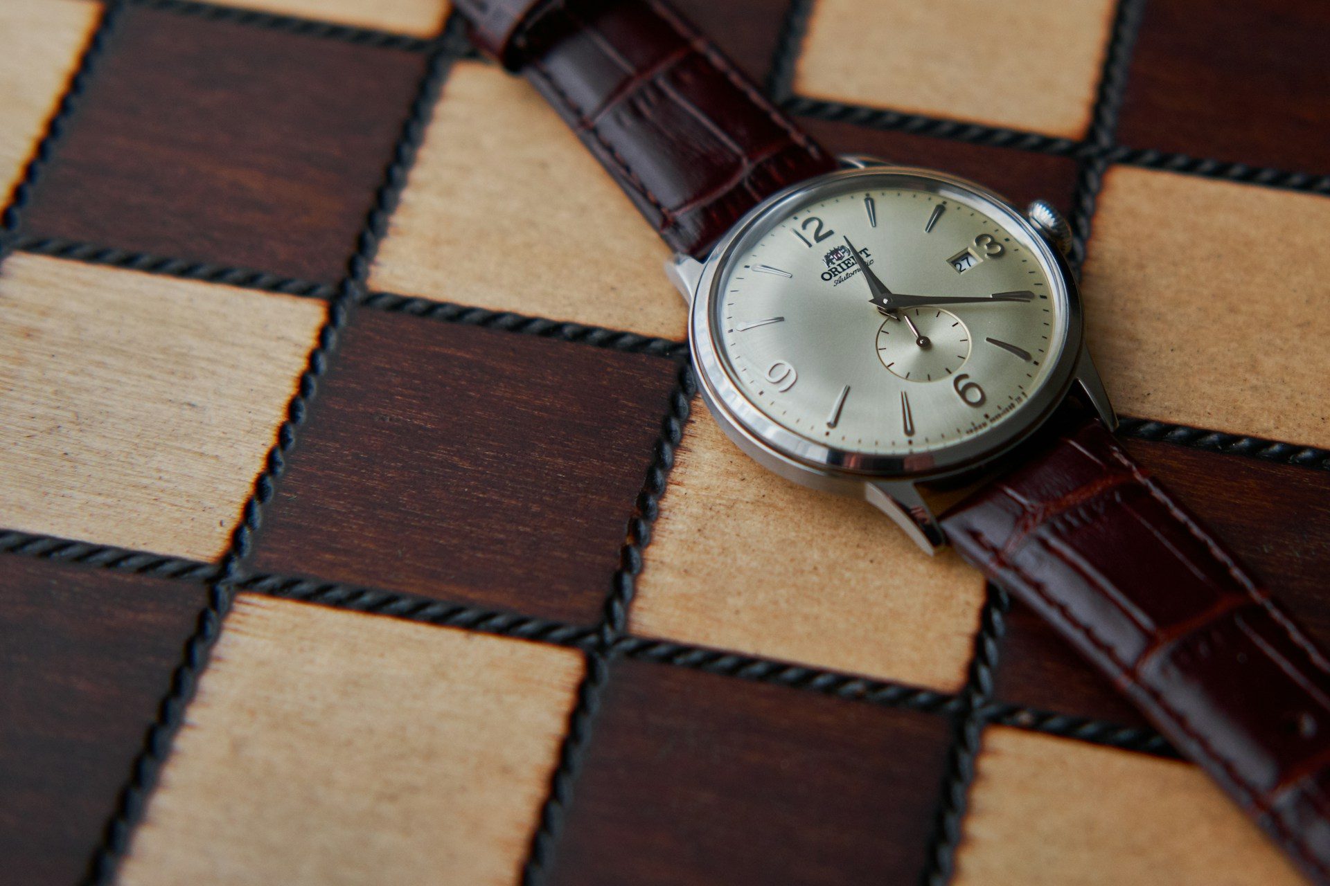 Orient watch on checkered table